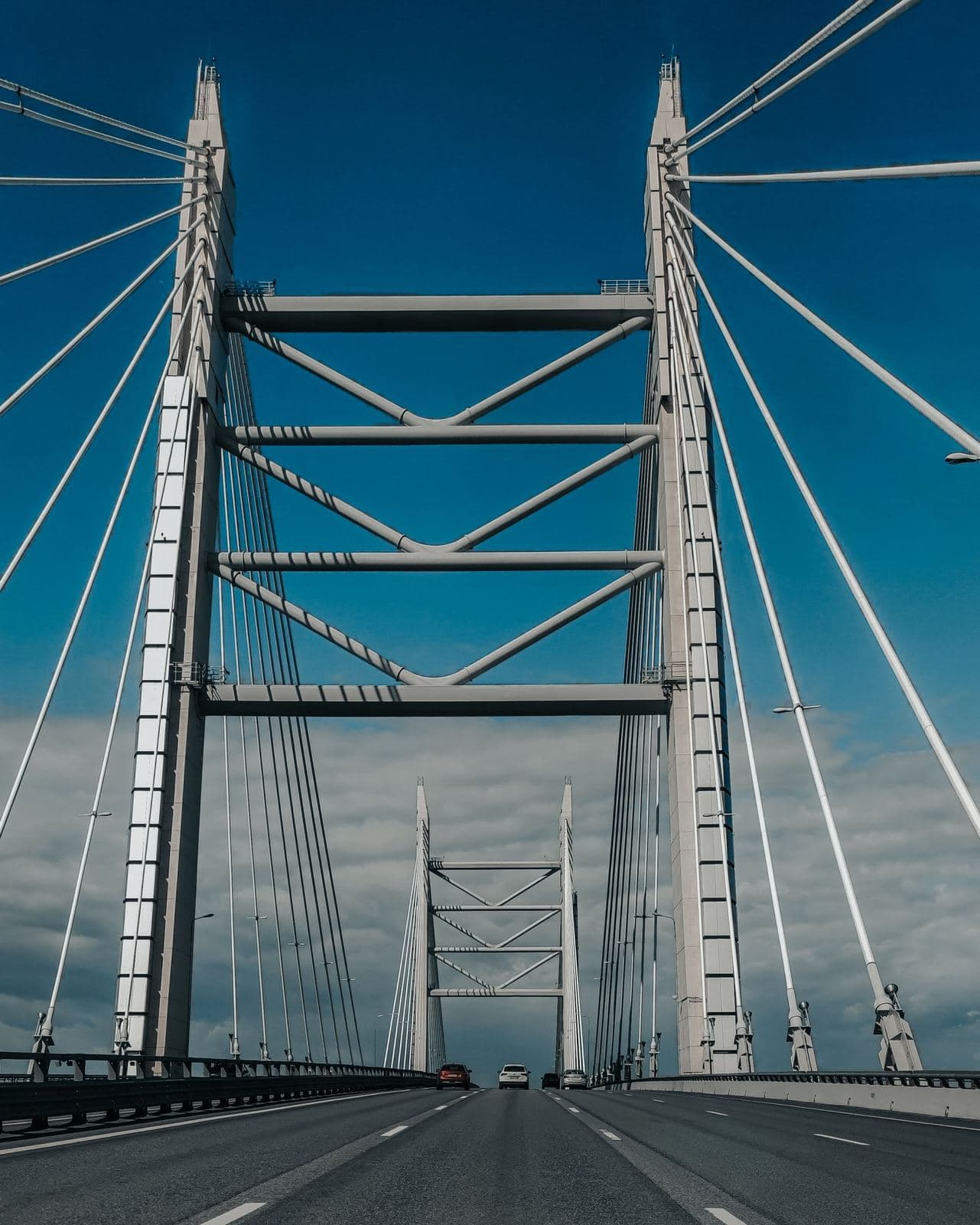 A cable-stayed bridge's twin towers and support cables, seen from the roadway