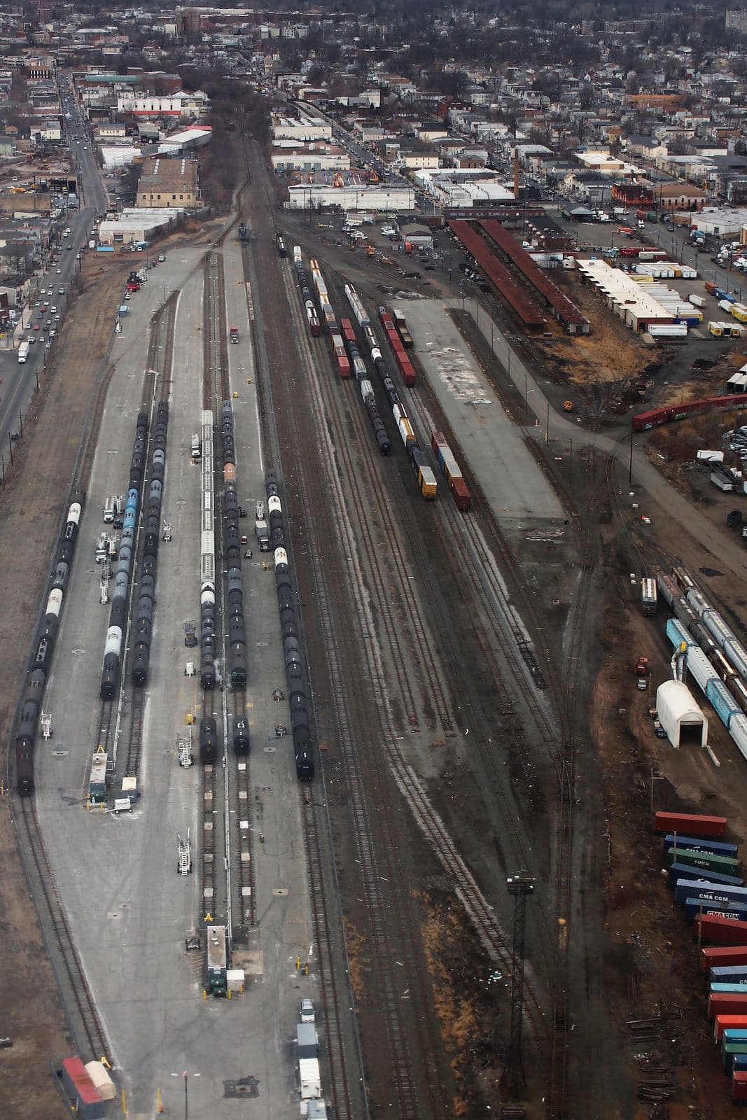 Aerial view of a Conrail rail yard in Elizabeth, New Jersey, with tank cars, boxcars, and stacked containers